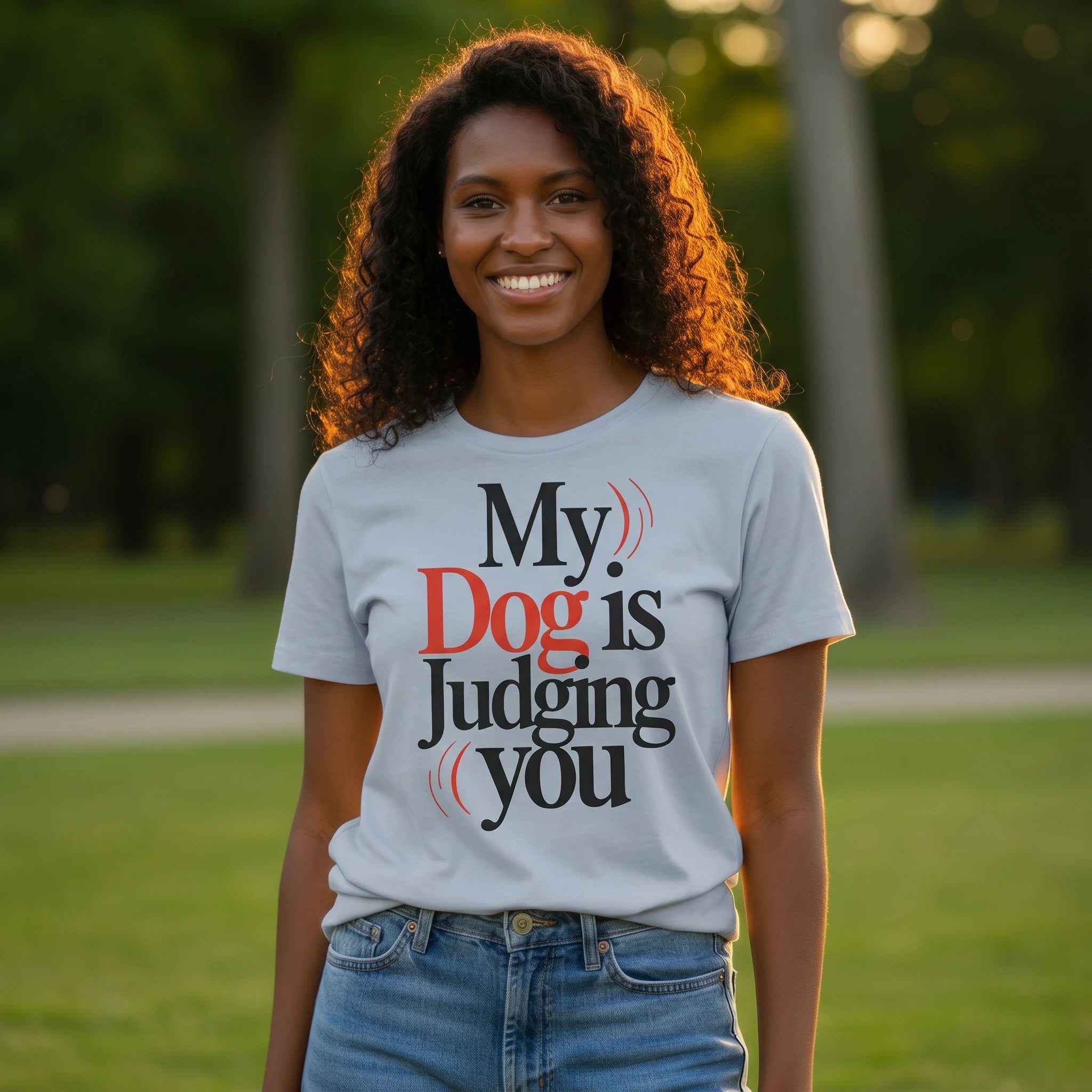 Woman wearing a t-shirt with 'My Dog is Judging You' text in a park setting