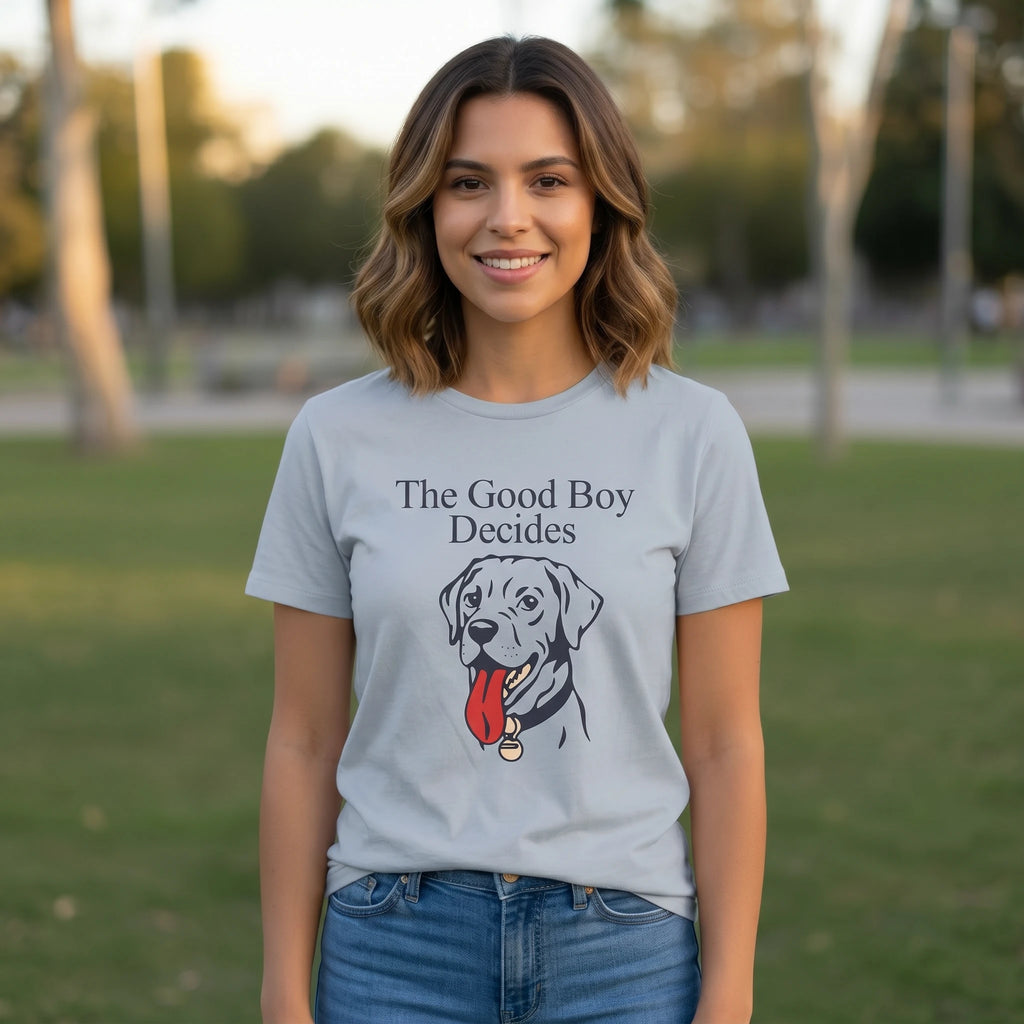 Woman wearing a t-shirt with a dog graphic and 'The Good Boy Decides' text in a park