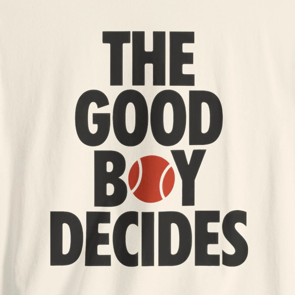 Text 'THE GOOD BOY DECIDES' with a red tennis ball on a beige background