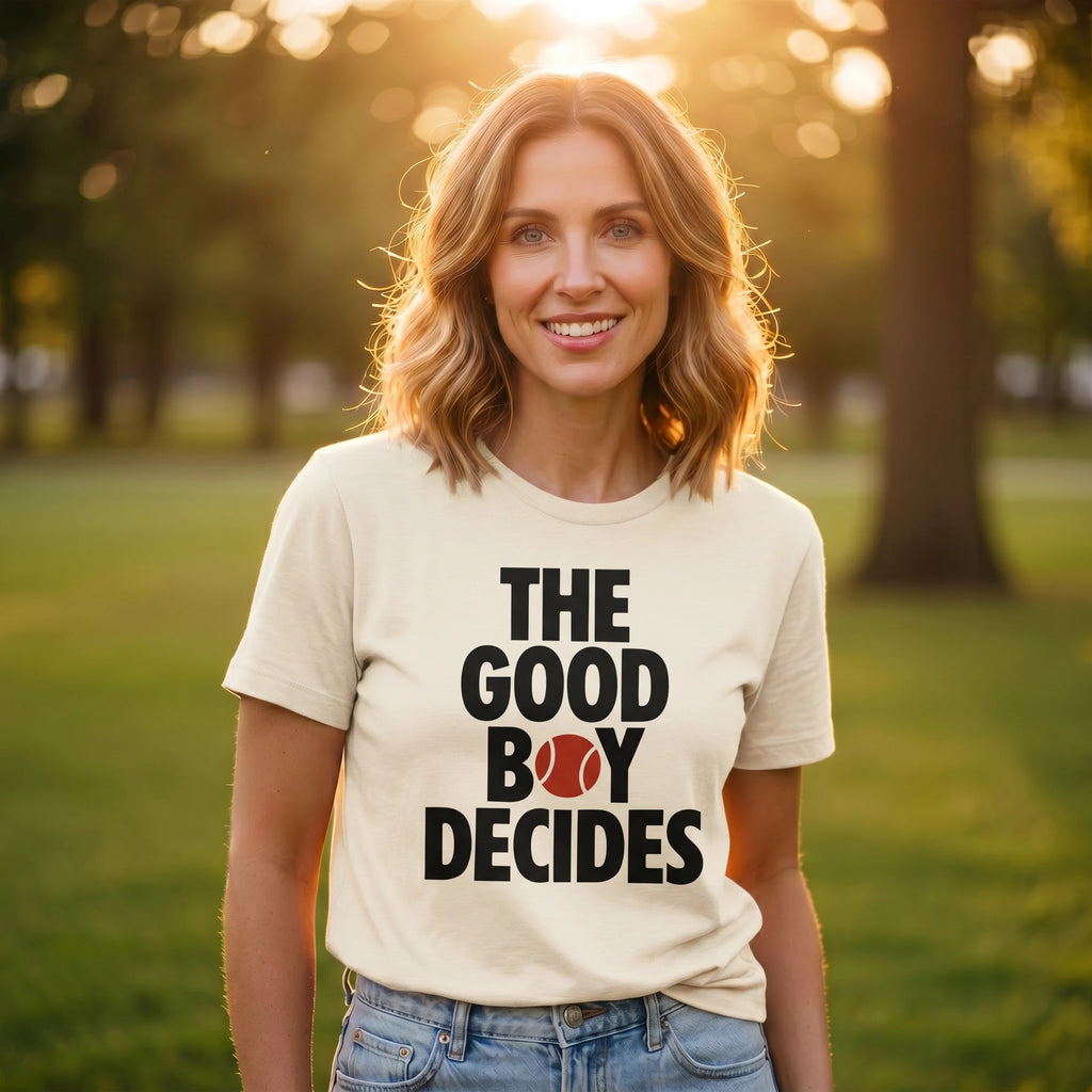 Woman wearing a t-shirt with 'The Good Boy Decides' text in a park setting