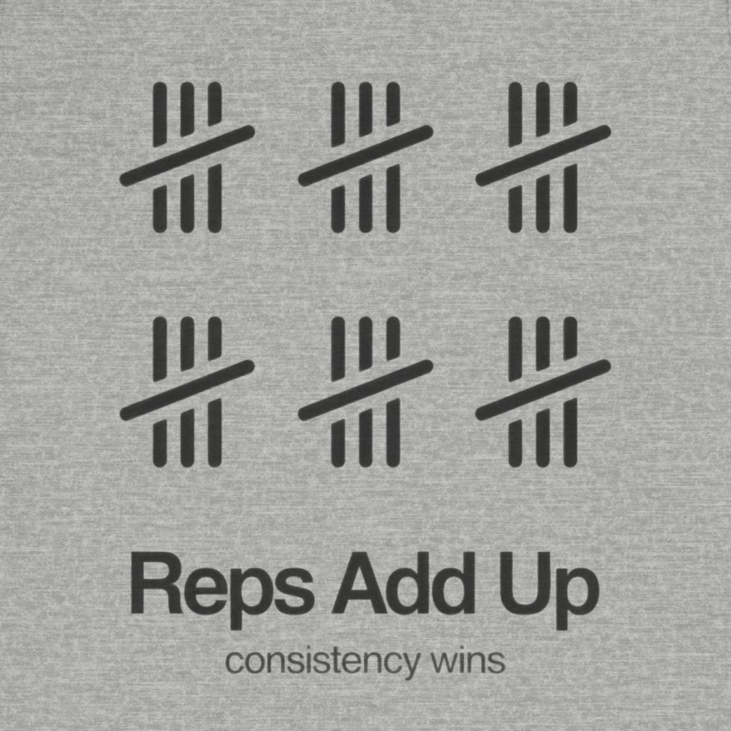 Gray t-shirt with black graphic design and text 'Reps Add Up, consistency wins' on a plain background