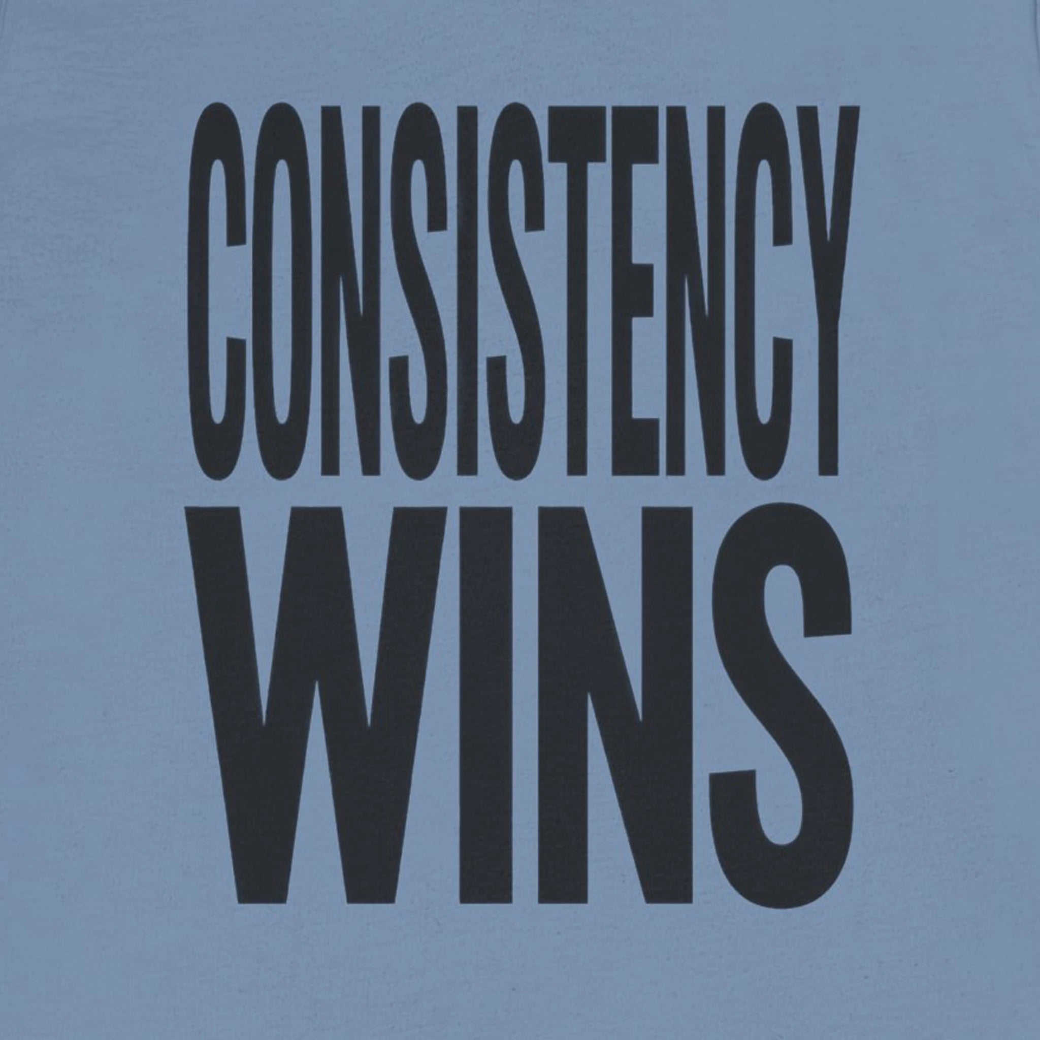 Blue t-shirt with 'CONSISTENCY WINS' text in black on a solid background