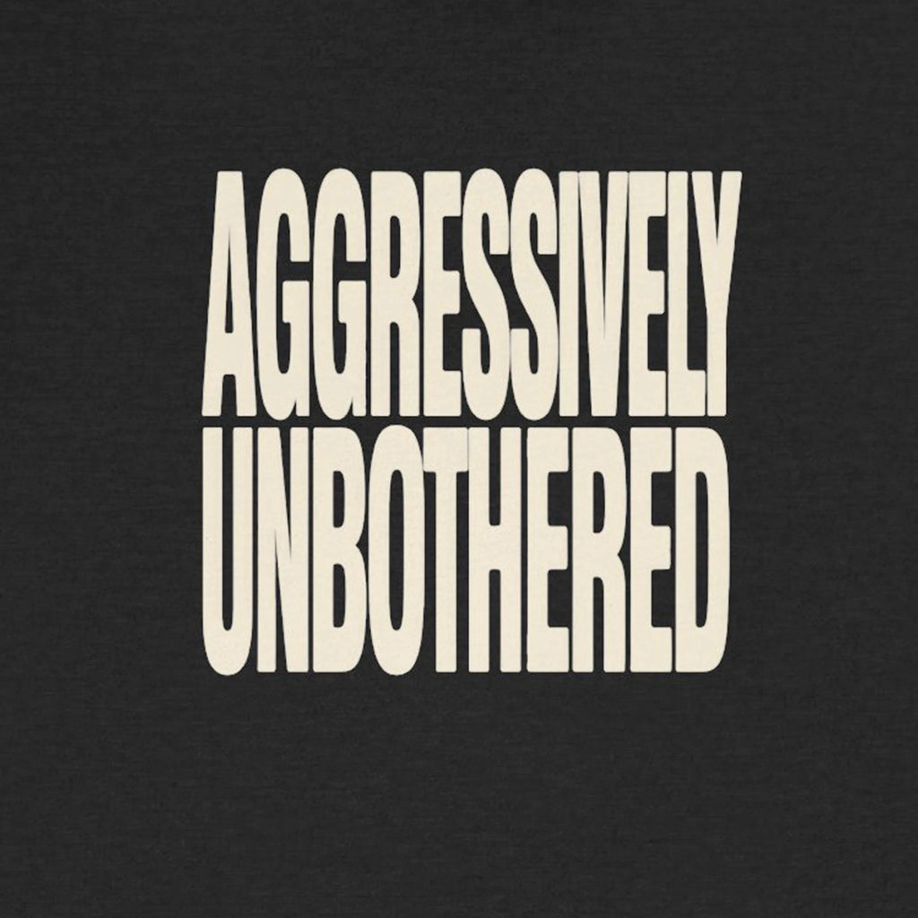 Text 'AGGRESSIVELY UNBOTHERED' on a black background