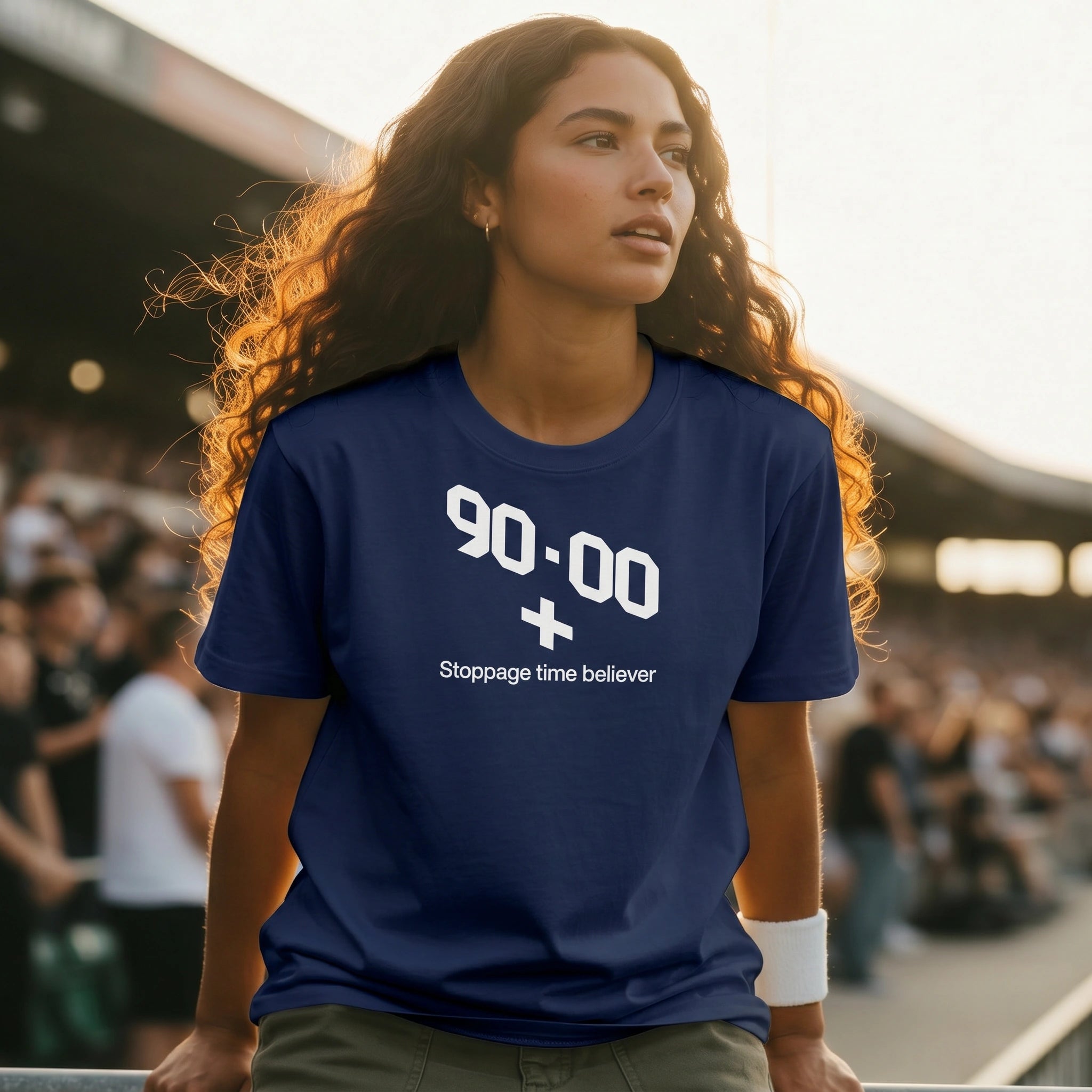 Woman wearing a blue t-shirt with text at a sports event