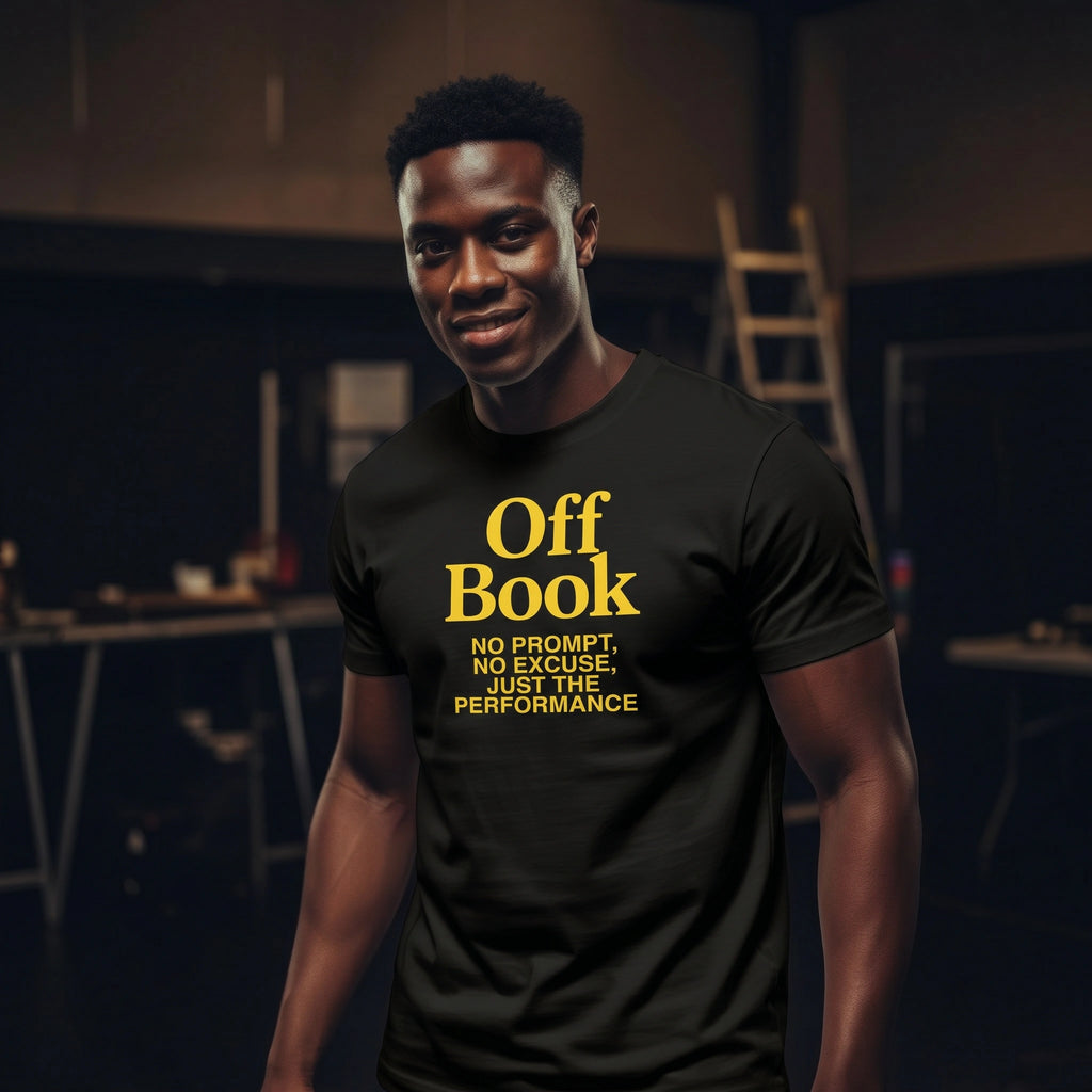 Person wearing a black t-shirt with yellow text in a dark room.