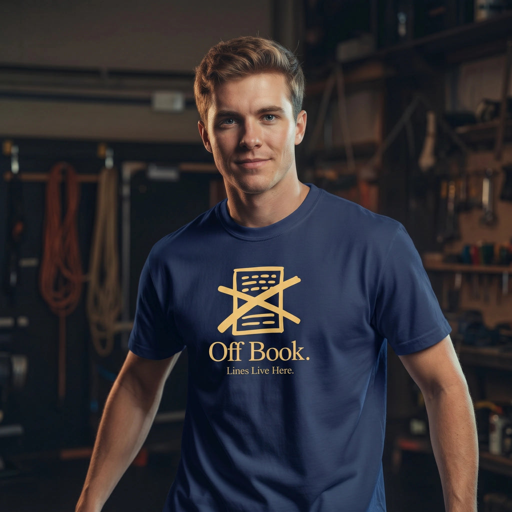 Man wearing a blue t-shirt with 'Off Book' logo in a back stage setting