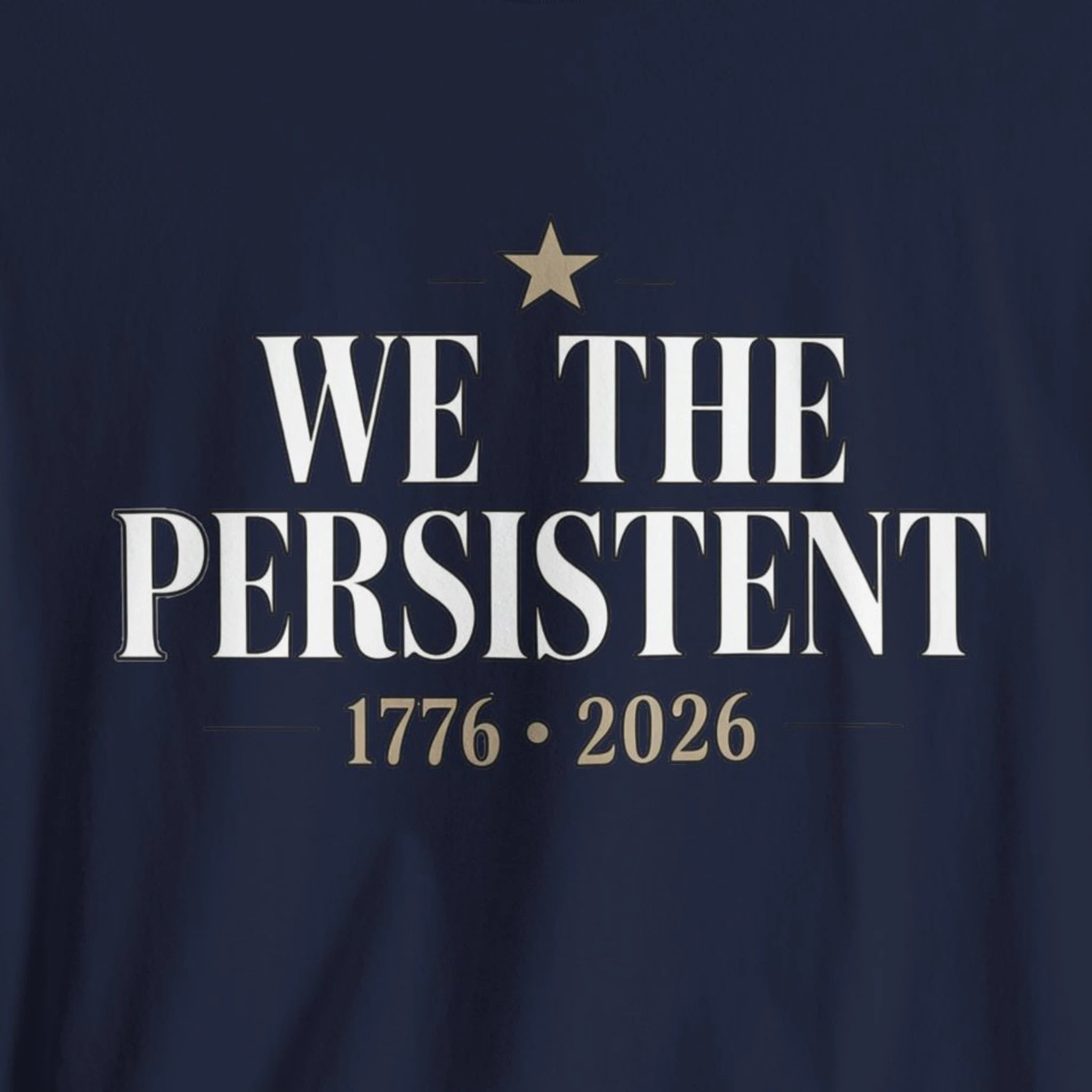 Navy blue shirt with 'We the Persistent' text and star design on a dark background