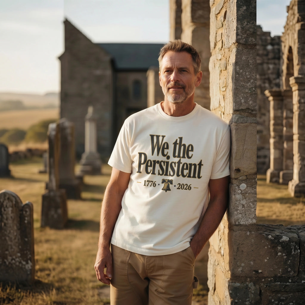 Man wearing a t-shirt with 'We the Persistent' text in a cemetery.