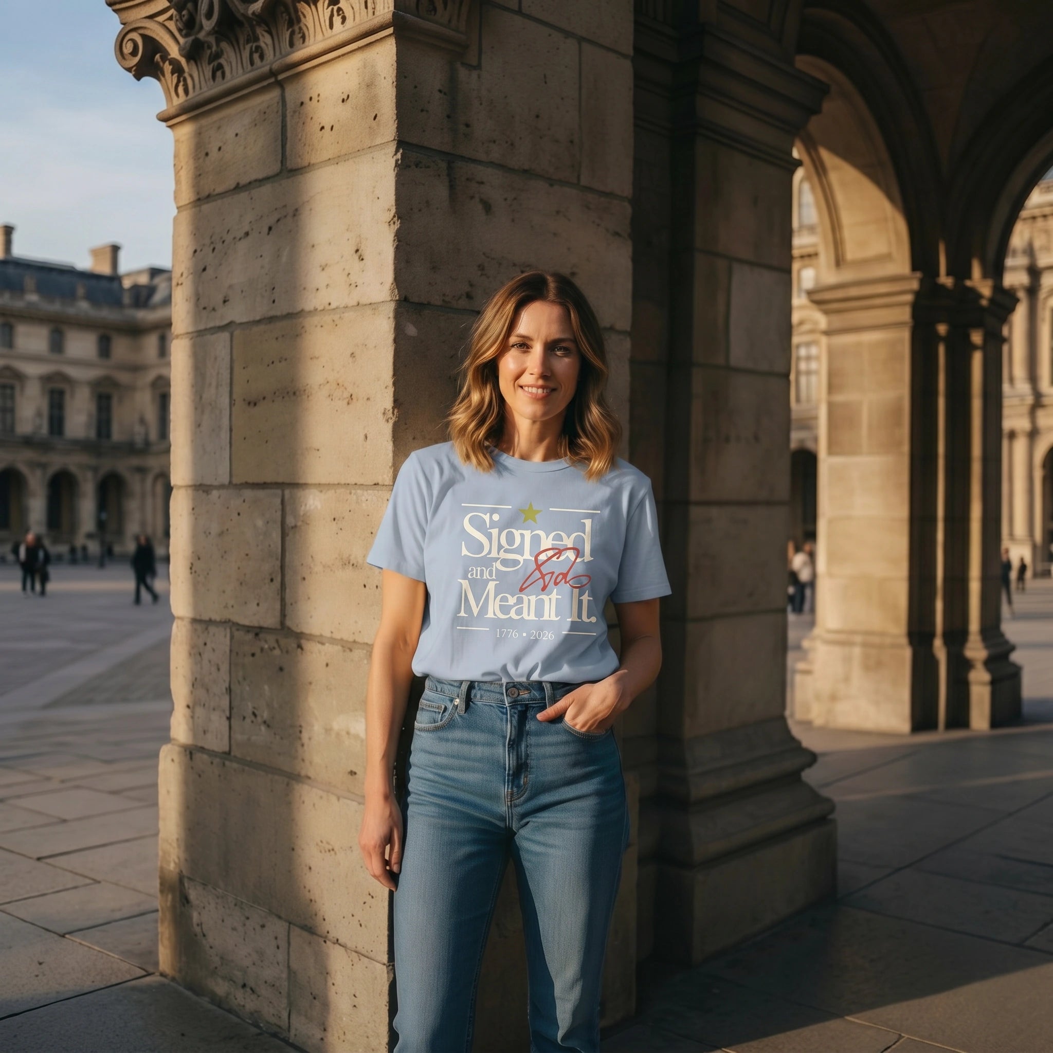Woman wearing a t-shirt with text standing in front of stone columns