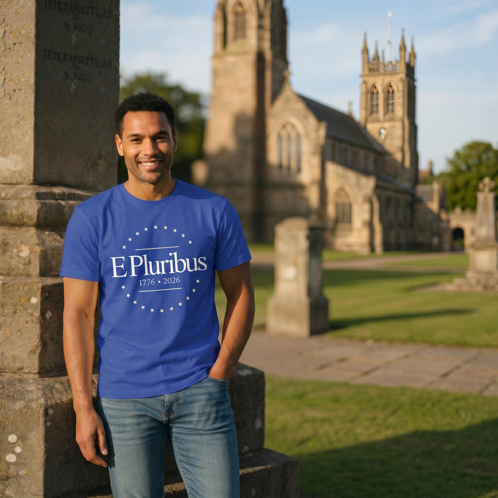 Man wearing a blue t-shirt with 'E Pluribus' text in front of a church.