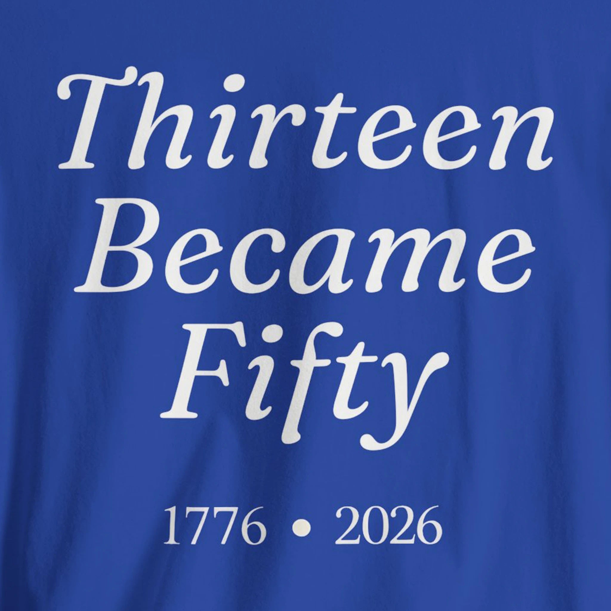 Blue fabric with white text 'Thirteen Became Fifty 1776 • 2026' 