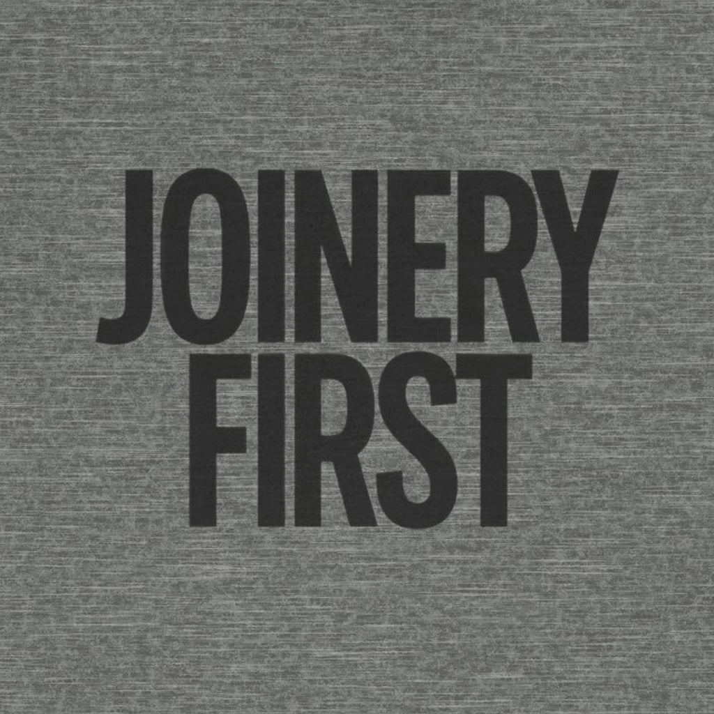 Gray t-shirt with 'JOINERY FIRST' text in black on a textured fabric background